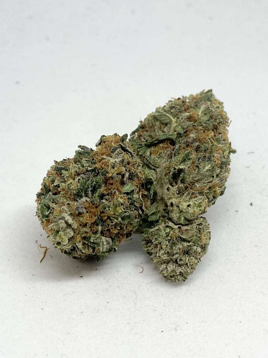 Grape Ape AAA indica cannabis flower bud, dense frosty nug with orange pistils, THC 17-23%