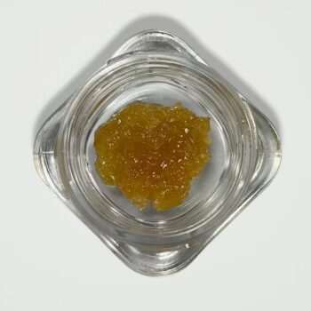 A top-down view of a glass jar containing 5 grams of golden House Live Resin, showing its crystalline, amber-colored texture on a white background.
