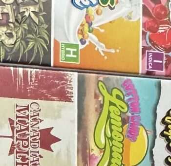 A collection of colorful vape juice boxes showcasing various flavors and brands arranged neatly.