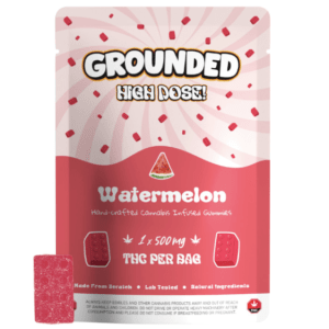 Grounded 500mg THC Brick - Watermelon, featuring vibrant pink packaging and a watermelon-flavored gummy, ideal for cannabis enthusiasts.