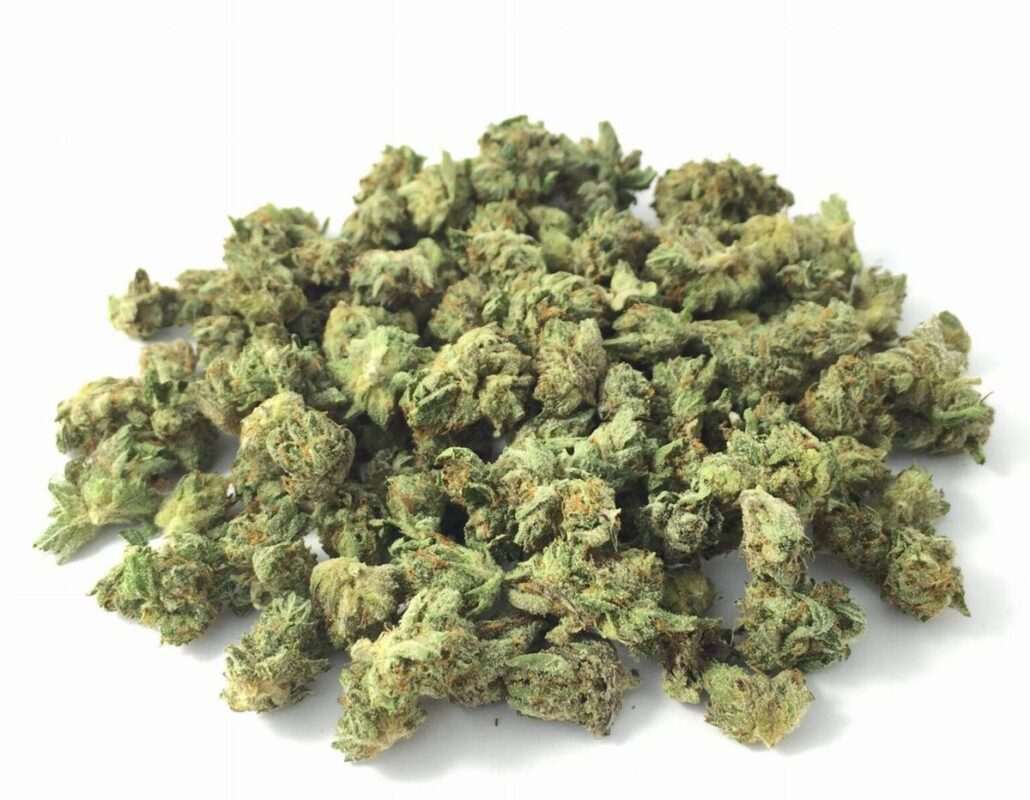 Close-up image of Pink Kush Smalls popcorn buds, a AAA indica cannabis flower with a THC range of 18%-23%.
